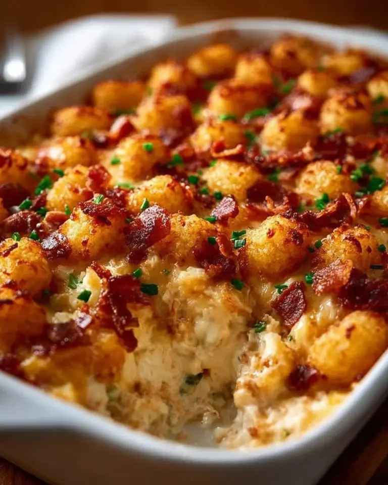 Chicken Bacon Ranch Tater Tot Casserole topped with crispy bacon and cheese