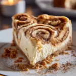 Delicious Cinnamon Roll Cheesecake topped with swirls of cinnamon and icing